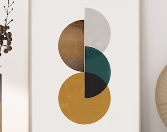 May include: Abstract geometric art print featuring overlapping circles in shades of brown, yellow, teal, and white. The print is framed in a light wood frame and is hanging on a white wall.