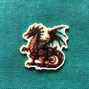 May include: A steampunk-style dragon with intricate gears and cogs, rendered in a detailed illustration. The dragon is brown and black with blue wings and is set against a turquoise background.