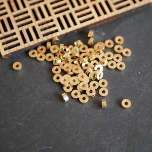 50 brass rondelle spacer beads in raw gold-plated brass, 2x5mm round beads