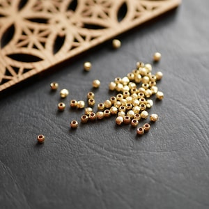 50 Small gold raw brass round spacer beads. 3mm. Textured ridged effect