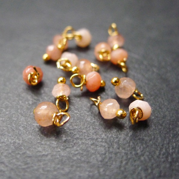 20 perles rondes à facettes en jade rose  corail et doré 4x8mm