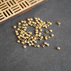 x50 pequeñas cuentas espaciadoras cuadradas de latón bañado en oro crudo, cuentas de 2,5 mm