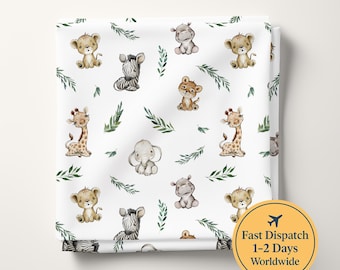 May include: A white fabric featuring a repeating pattern of illustrated baby animals including a lion, zebra, hippo, leopard, giraffe, and elephant, interspersed with green leafy sprigs. The design is printed on a soft, folded textile material.