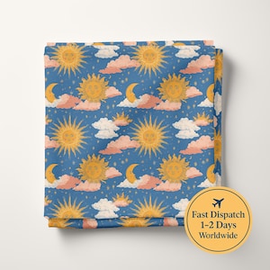 May include: A blue fabric featuring a repeating pattern of yellow suns with faces, yellow crescent moons with faces, pink and white clouds, and small yellow stars scattered across the surface. The design is consistent and covers the entire visible area.