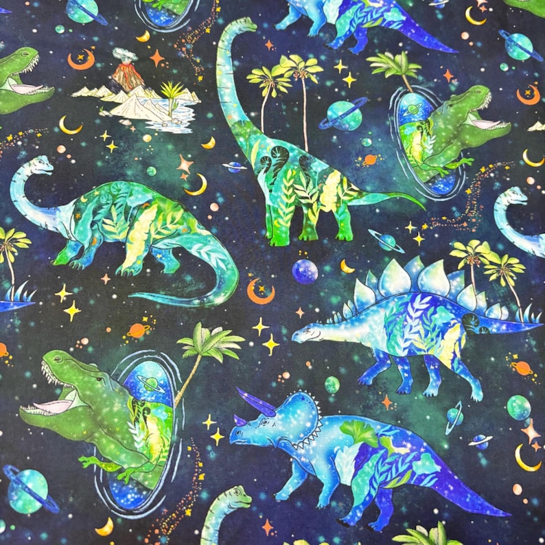 May include: A fabric pattern featuring various dinosaurs in a space-themed design. The dinosaurs are in shades of green and blue, with a starry night sky background. Palm trees, planets, and crescent moons are also present.