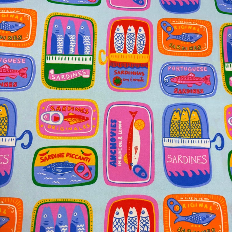 May include: A repeating pattern of colorful sardine and anchovy tins on a light blue background. The tins feature illustrations of fish and text in various languages, including "Sardines" and "Anchovies". The design is vibrant and playful.
