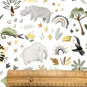May include: Watercolor pattern featuring jungle animals like a hippo, elephant, toucan, and crocodile, along with rainbows, stars, and suns. The design includes a ruler showing inches. The overall theme is a whimsical safari.