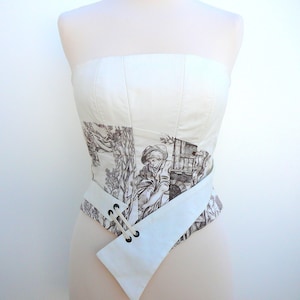 Asymmetrical corseted bustier in canvas of Jouy, ecru and brown.