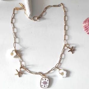 Gold stainless steel chain necklace with starfish and flower medallion charms