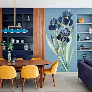May include: A dining room with a large wall mural of dark blue iris flowers. The room features a dark wood table with yellow chairs, a blue sofa, and built-in shelves. A gold and blue light fixture hangs above the table.