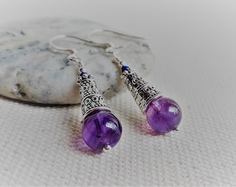 May include: A pair of silver dangle earrings with amethyst gemstone beads and ornate silver accents.