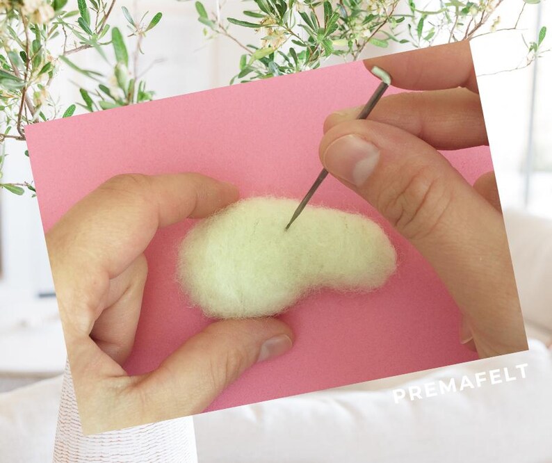 The picture shows the process of making a figure out of wool with needle felting