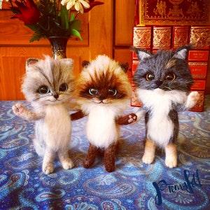 The picture shows a replica of a toy cats made of wool, which was made to order
