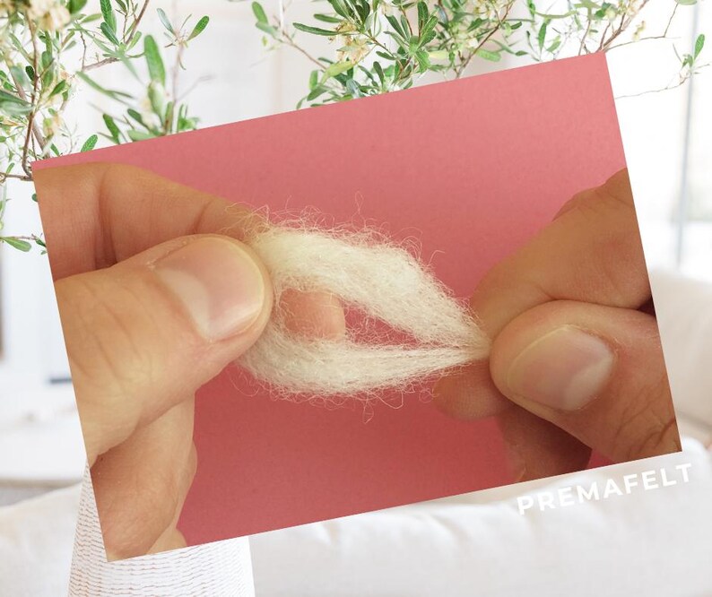 The picture shows the process of making a figure out of wool with needle felting