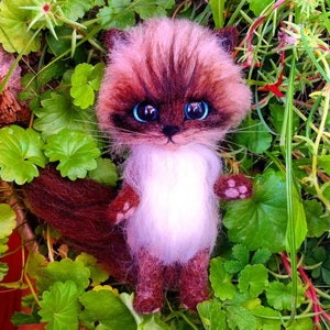 The picture shows a replica of a toy cat made of wool, which was made to order