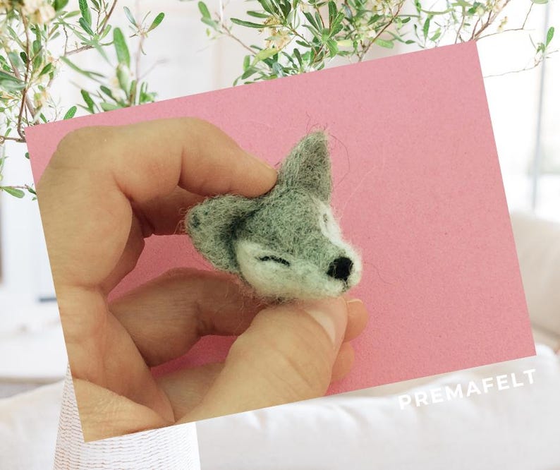 The picture shows the process of making a figure out of wool with needle felting