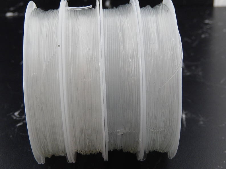 May include: Four spools of white filament for 3D printing.