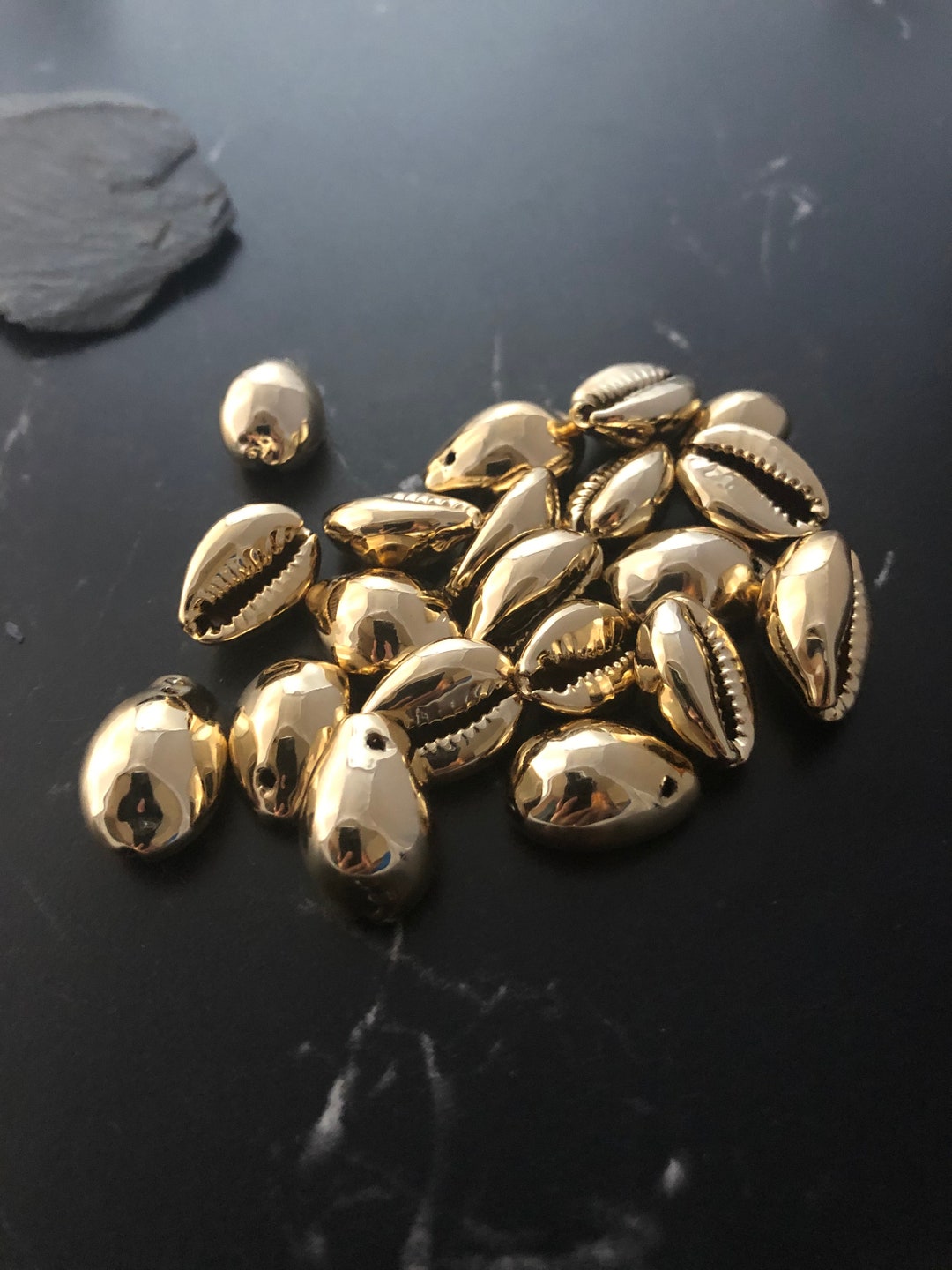 Gold plated cowrie shells deals