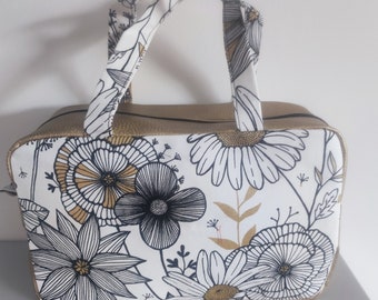 Trousse de toilette motif fleurs noir doré, entièrement doublé, 2 poches interieur, grande ouverture de 35 cm, travail soigné.