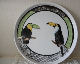 Pie dish in hand painted china decorated with two toucans.