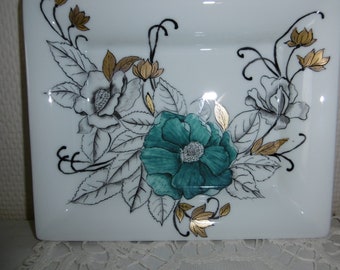 Hand painted china trinket tray decorated with a blue flower and grey flowers with leaves and mat gold