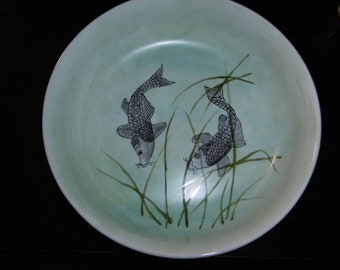 Hand-painted porcelain bowl with a Japanese-inspired pattern of two gray fish