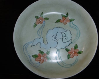 Hand-painted porcelain bowl with Japanese-inspired pattern of clouds and flowers