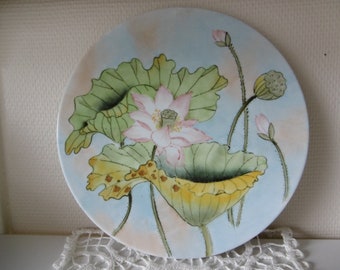 Round hand-painted porcelain dish with lotus motif