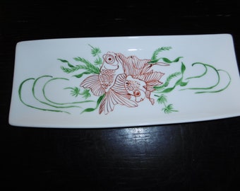 Sushi tray in hand painted china decorated with two red fish and green sea weeds