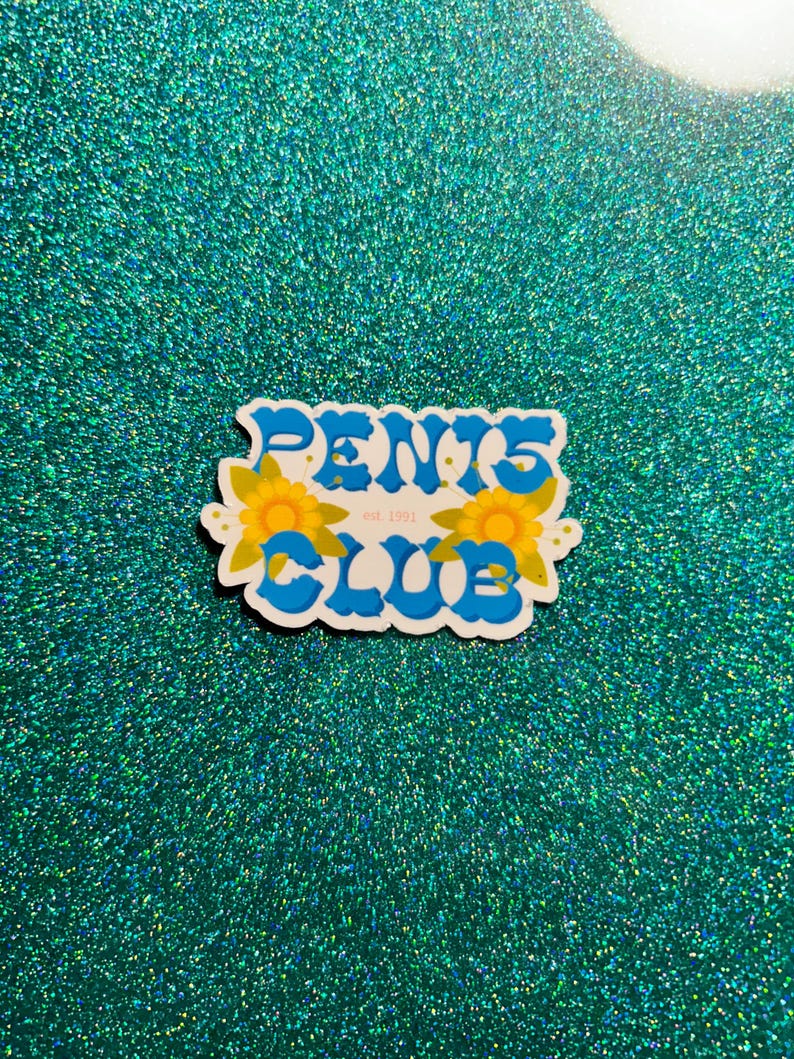May include: A blue and white sticker with the text "PENTS CLUB est. 1991" in a retro font. The sticker is decorated with two yellow flowers.