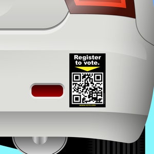 May include: A black and white QR code with a yellow arrow pointing down. The text "Register to vote." is above the QR code. The text "www.vote.org" is below the QR code. The QR code is on a white car bumper.