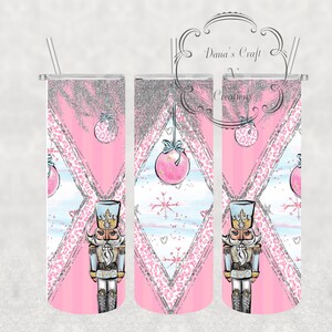 May include: Three pink and white stainless steel tumblers with a nutcracker, snowflake, and Christmas ornament design. The tumblers have a glitter finish and a leopard print pattern.
