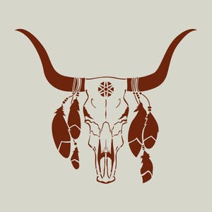 May include: A brown bull skull silhouette with long horns, a decorative emblem, and hanging feathers. The design is set against a neutral background, evoking a rustic or Southwestern aesthetic.