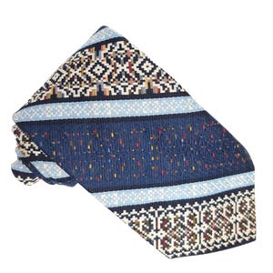 May include: A patterned necktie with a geometric design. The tie features a dark blue center with flecks of color, bordered by light blue stripes and detailed geometric patterns in white, black, and brown. The tie is folded.