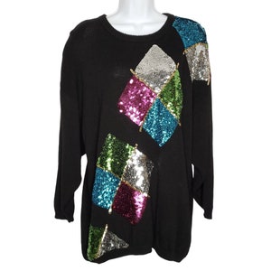 May include: Black sweater with a colorful sequined diamond pattern. The sequins are in shades of green, blue, pink, and silver.