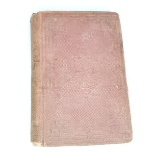 May include: A vintage, brown, hardback book with a decorative embossed design on the cover. The book has a spine with a title and author's name.