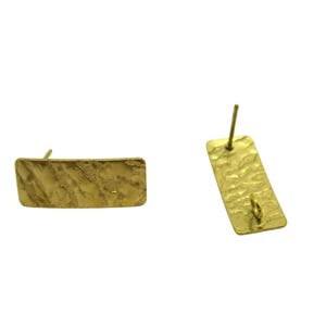 May include: A pair of gold-coloured rectangular stud earrings. The earrings have a hammered texture and a post for insertion. One earring is horizontal, the other vertical, showing the post and the loop for the earring back.