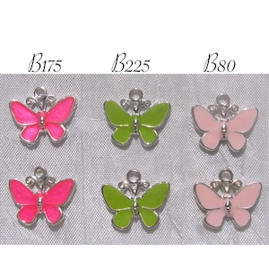 May include: Six silver butterfly charms with enamel paint. Two pink, two green, and two light pink butterflies.