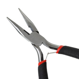May include: Close-up of needle-nose pliers with a silver metal finish. The pliers have black handles with red accents near the pivot point. The tips are long and pointed, designed for precision work.