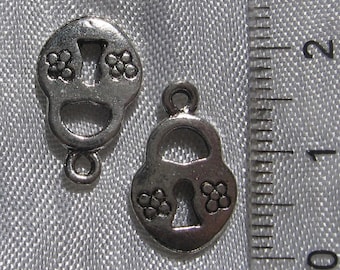 May include: Two silver lock charms with a keyhole and floral designs. The charms are approximately 1 inch in size.