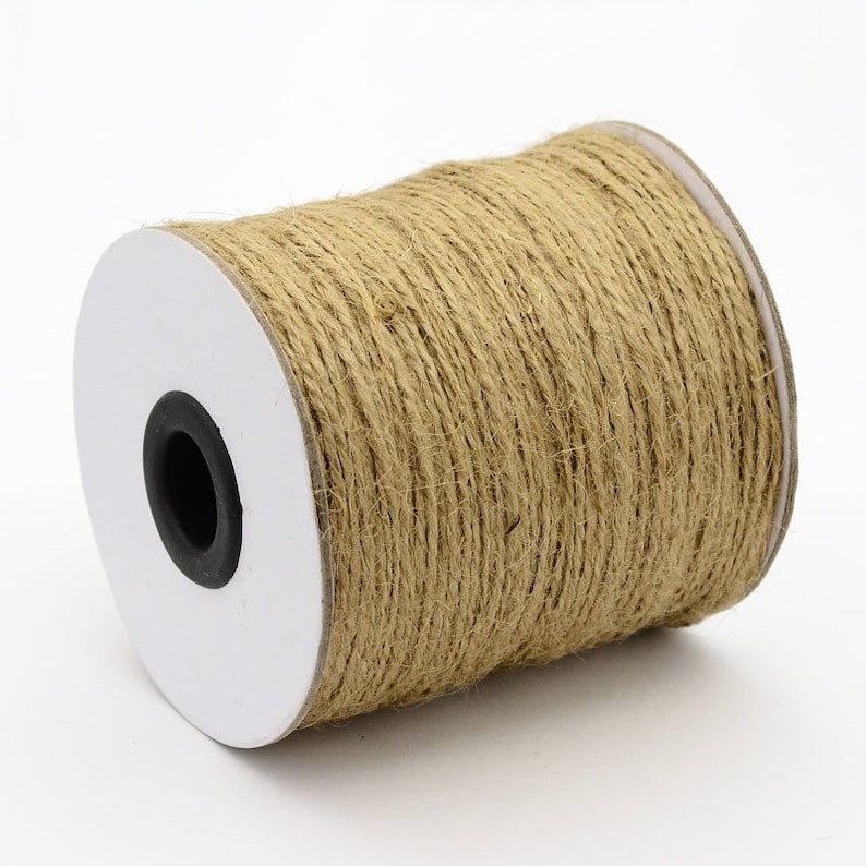 May include: A roll of natural brown twine, wrapped around a white cardboard core. The twine is made of natural fibers and is perfect for crafting, wrapping, and decorating.