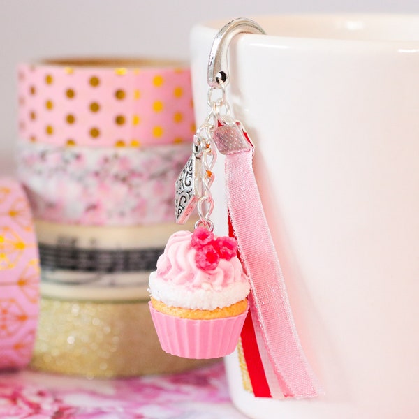 Realistic Raspberry Cupcake bookmark with a pink and coconut base mounted on a silver support with matching ribbons