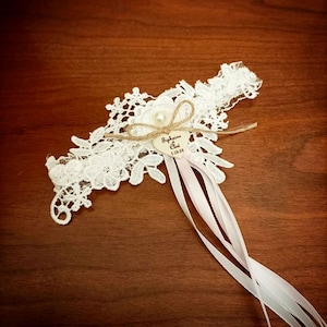 personalized lace and wooden heart garter for a bohemian country wedding