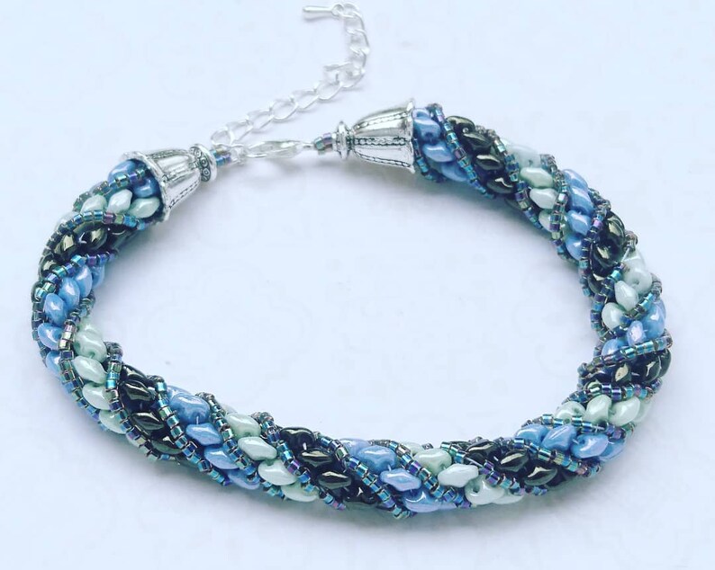 Needle-woven Flavie bracelet spiraled with Matubo superduo beads and Miyuki D\u00e9licas greenbluebronze primers without nickel