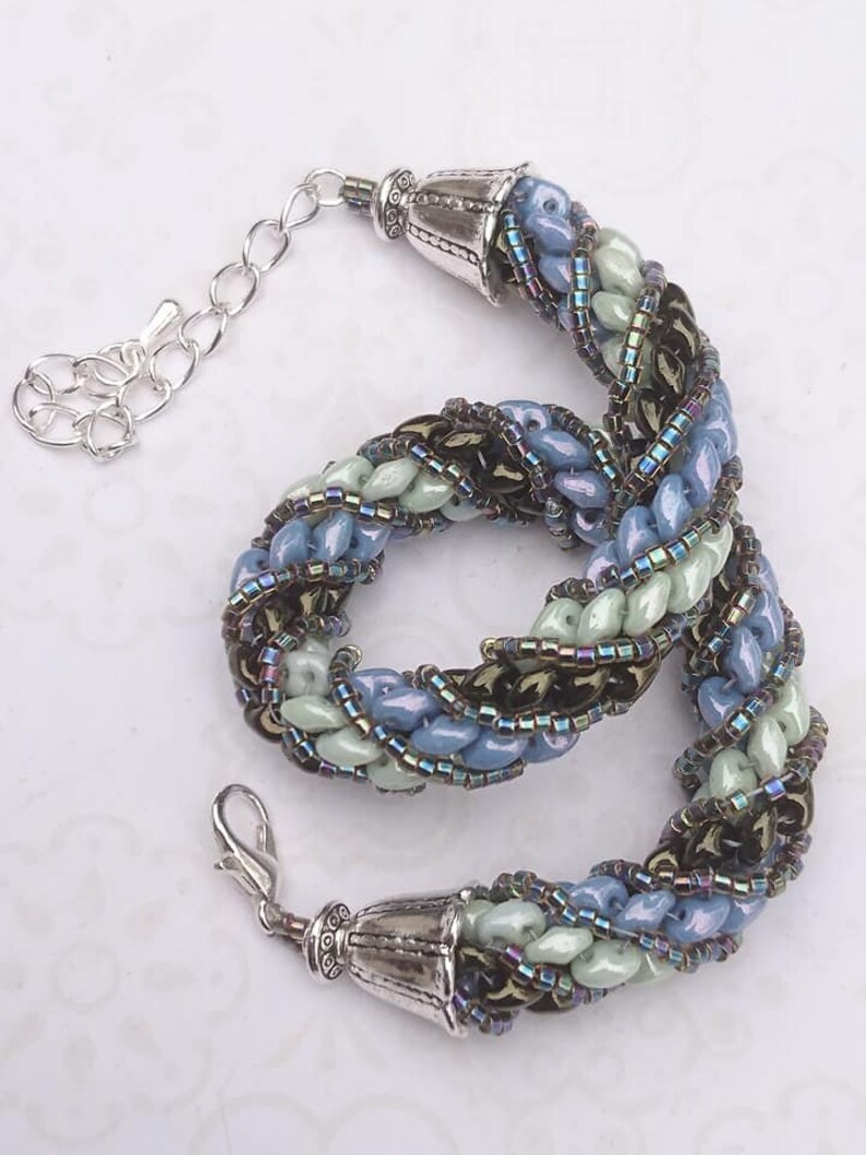Needle-woven Flavie bracelet spiraled with Matubo superduo beads and Miyuki D\u00e9licas greenbluebronze primers without nickel