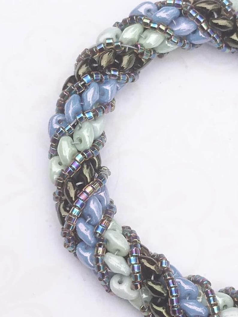 Needle-woven Flavie bracelet spiraled with Matubo superduo beads and Miyuki D\u00e9licas greenbluebronze primers without nickel