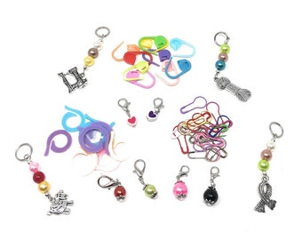 May include: Assortment of colorful stitch markers, including plastic, metal, and beaded options. Some markers feature charms, such as a heart, a sewing machine, and a yarn ball.