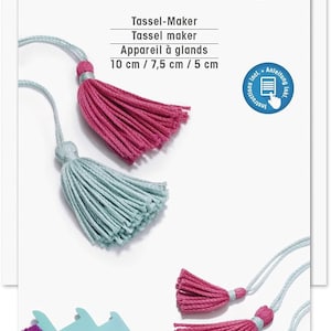 May include: A blue and pink tassel maker with a spool of purple yarn. The tassel maker has three settings for different tassel sizes: 5 cm, 7.5 cm, and 10 cm. The packaging includes instructions.
