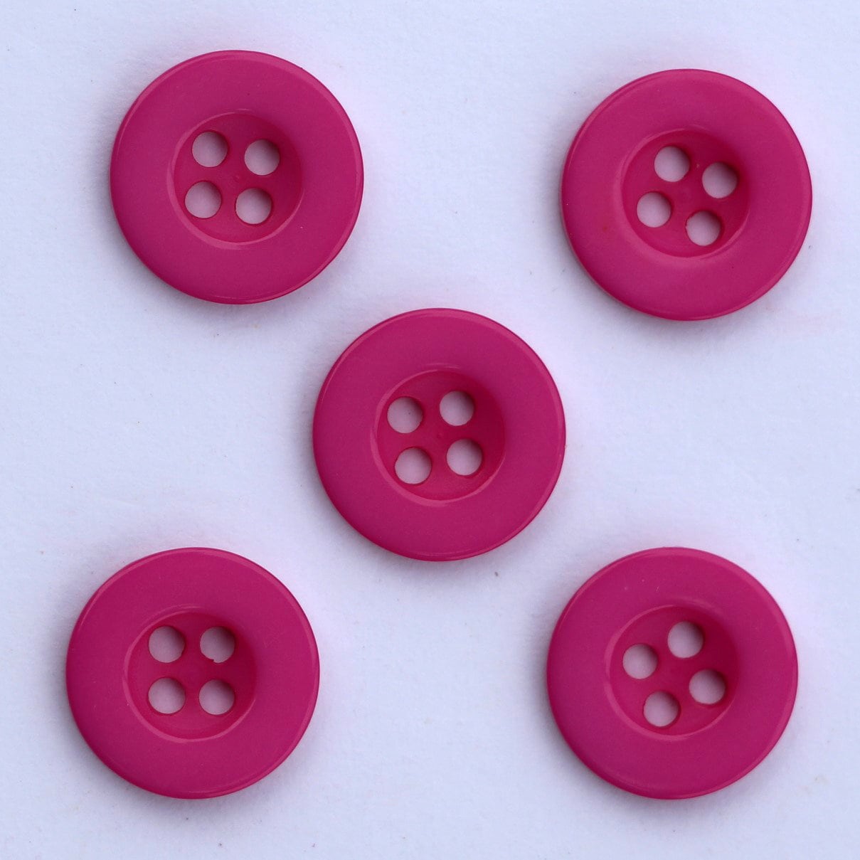 SET OF THREE PINK PLASTIC 1 1/8 DIA. ROUND 2-HOLE SEWING BUTTONS