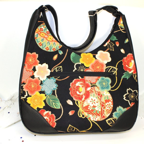 Bag Black, Japanese patterns, flowers, black faux leather, large central pocket, zipper, adjustable strap, metal legs.